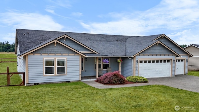 17133 123rd Ct SE, Yelm, WA 98597 - view of front facade featuring a garage, driveway, a shingled roof, and covered porch