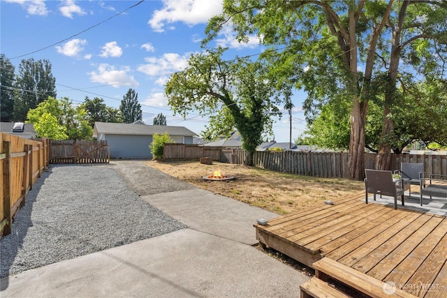 3914 N Gove St, Tacoma, WA 98407 - fenced backyard with an outdoor fire pit and a wooden deck