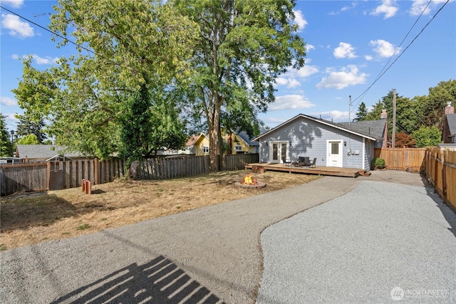 3914 N Gove St, Tacoma, WA 98407 - view of front of house with a wooden deck, a fenced backyard, driveway, and a patio
