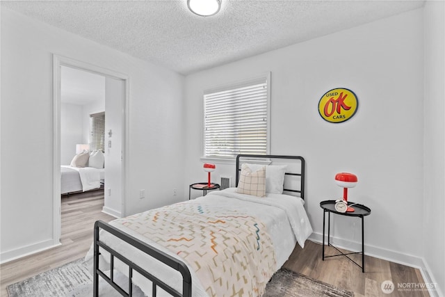 3914 N Gove St, Tacoma, WA 98407 - bedroom featuring wood finished floors and a textured ceiling