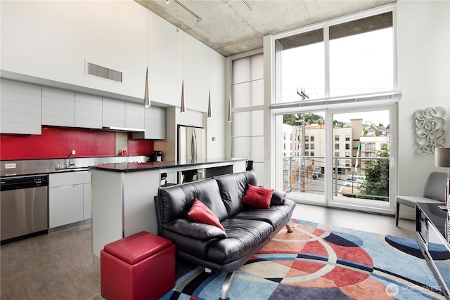 500 Mercer St Unit R325, Seattle, WA 98109 - living area with concrete flooring, a high ceiling, and rail lighting