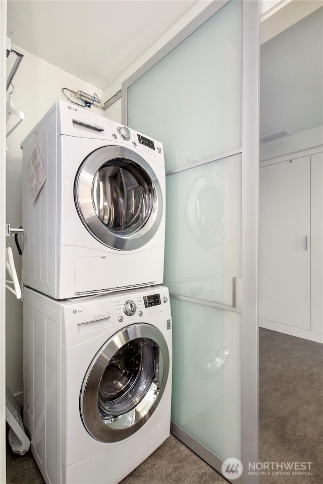 500 Mercer St Unit R325, Seattle, WA 98109 - laundry area with stacked washer and clothes dryer and carpet floors