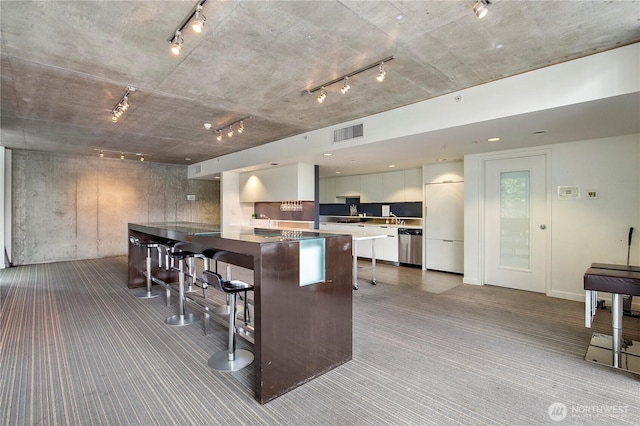 500 Mercer St Unit R325, Seattle, WA 98109 - kitchen with track lighting, carpet floors, a kitchen breakfast bar, modern cabinets, and dishwasher