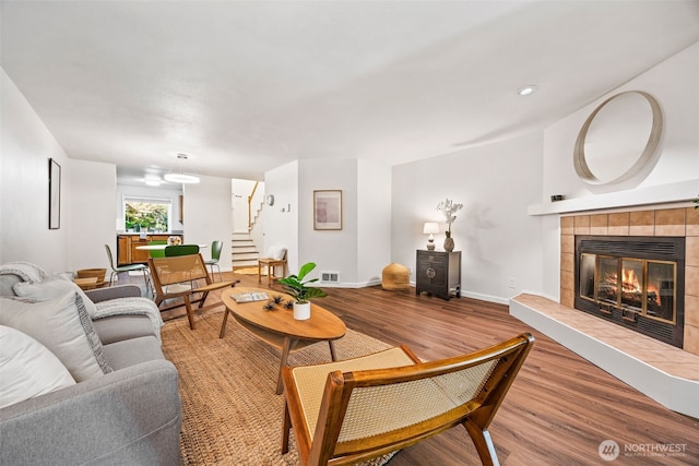 9522 1st Ave NE Unit B6, Seattle, WA 98115 - living area with wood finished floors, stairs, and a tile fireplace