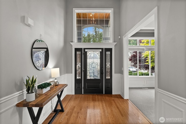 32216 Bruckners Way, Black Diamond, WA 98010 - entrance foyer featuring a wainscoted wall, healthy amount of natural light, wood finished floors, and a decorative wall