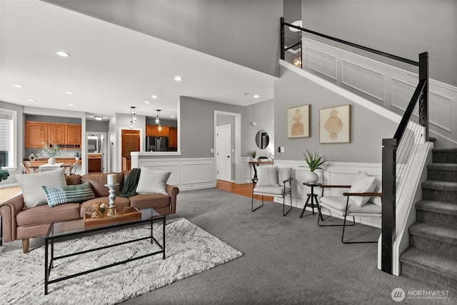 32216 Bruckners Way, Black Diamond, WA 98010 - carpeted living area featuring stairs, recessed lighting, and wainscoting