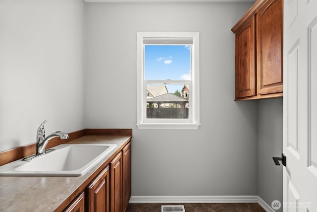 32216 Bruckners Way, Black Diamond, WA 98010 - laundry room with a sink and baseboards