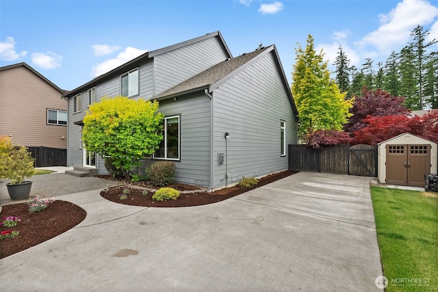 32216 Bruckners Way, Black Diamond, WA 98010 - view of side of property with a gate, a storage shed, a shingled roof, and crawl space