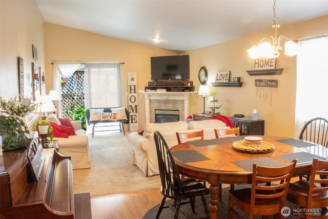 24320 226th Ave SE, Maple Valley, WA 98038 - dining space with a fireplace, vaulted ceiling, and wood finished floors