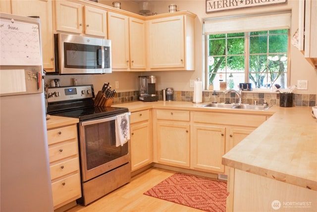 24320 226th Ave SE, Maple Valley, WA 98038 - kitchen featuring stainless steel appliances, light brown cabinets, light countertops, and light wood-style flooring