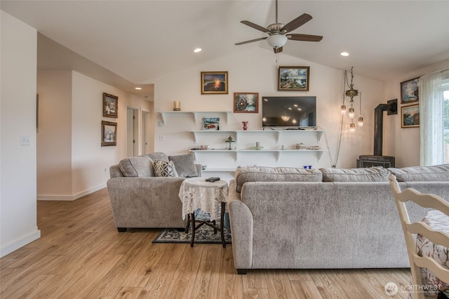 420 Point Brown Ave SE, Ocean Shores, WA 98569 - living area with ceiling fan, a wood stove, light wood finished floors, vaulted ceiling, and recessed lighting