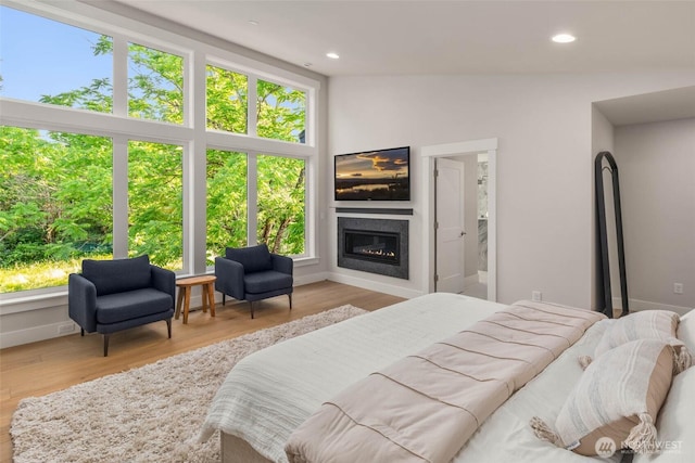 21025 SE 80th St, Issaquah, WA 98027 - bedroom with a glass covered fireplace, wood finished floors, and recessed lighting