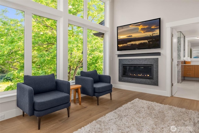 21025 SE 80th St, Issaquah, WA 98027 - sitting room with a glass covered fireplace and wood finished floors