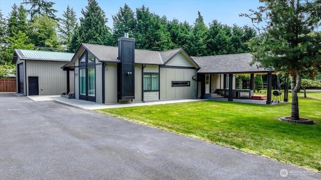 5109S 364th St, Auburn, WA 98001 - view of front of property with a chimney, a front lawn, board and batten siding, and a shingled roof