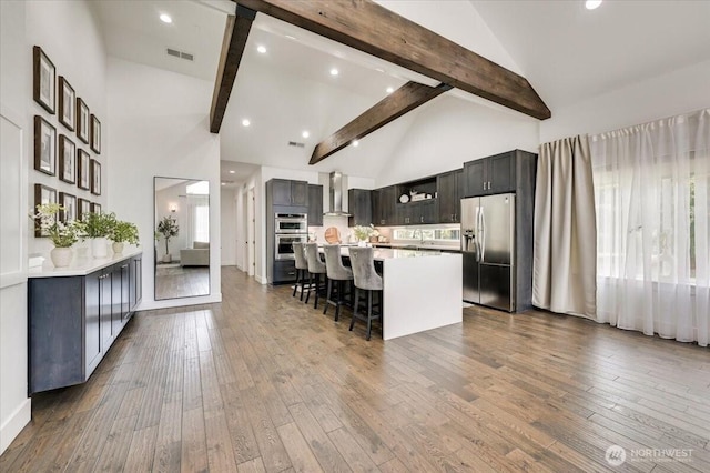 5109S 364th St, Auburn, WA 98001 - kitchen with appliances with stainless steel finishes, wall chimney exhaust hood, high vaulted ceiling, light countertops, and dark wood-style floors