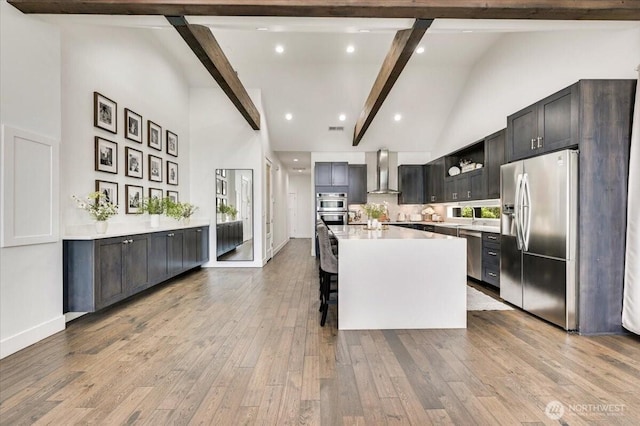 5109S 364th St, Auburn, WA 98001 - kitchen with stainless steel appliances, wall chimney exhaust hood, high vaulted ceiling, beam ceiling, and light countertops