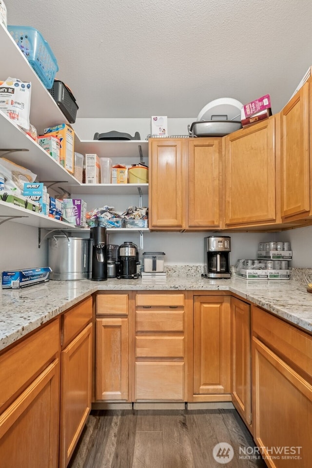1105 Nunnally Ave NW, Orting, WA 98360 - kitchen with dark wood finished floors, open shelves, and light stone counters