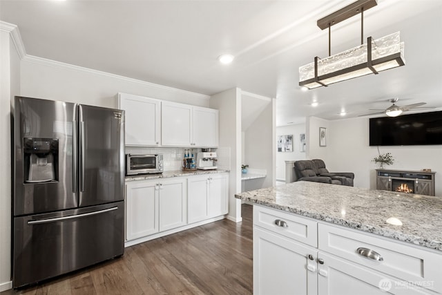 1105 Nunnally Ave NW, Orting, WA 98360 - kitchen featuring stainless steel refrigerator with ice dispenser, white cabinets, dark wood finished floors, light stone countertops, and crown molding