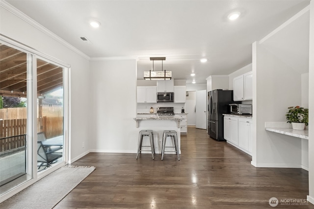 1105 Nunnally Ave NW, Orting, WA 98360 - kitchen featuring stainless steel microwave, refrigerator with ice dispenser, a peninsula, white cabinetry, and crown molding