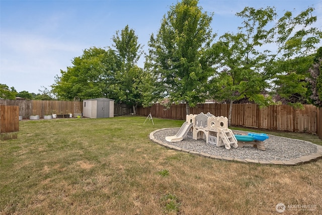 1105 Nunnally Ave NW, Orting, WA 98360 - fenced backyard featuring a storage unit and a playground