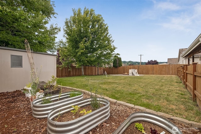 1105 Nunnally Ave NW, Orting, WA 98360 - fenced backyard featuring a garden