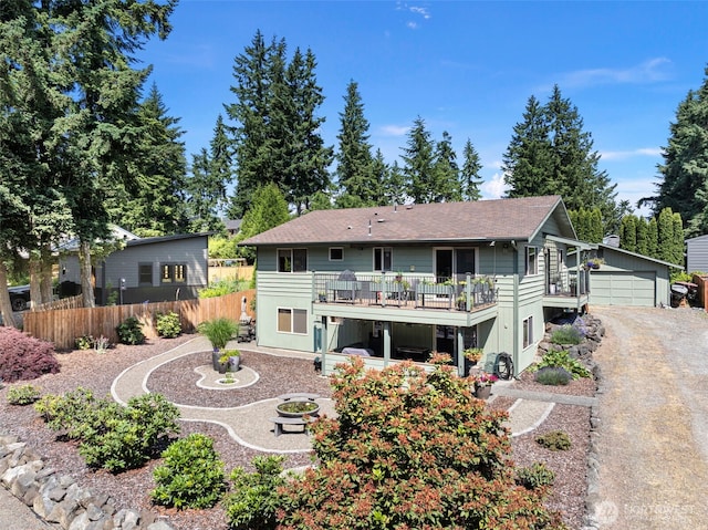 134 Robin Ln, Port Ludlow, WA 98365 - back of house with an outbuilding, a wooden deck, a garage, and a shingled roof