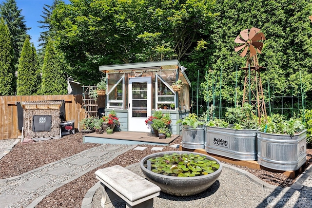 134 Robin Ln, Port Ludlow, WA 98365 - view of patio / terrace with a greenhouse, an outdoor structure, and a vegetable garden