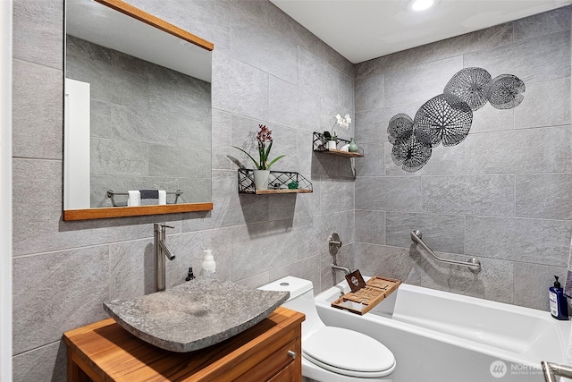 134 Robin Ln, Port Ludlow, WA 98365 - bathroom featuring tile walls, vanity, and bathtub / shower combination
