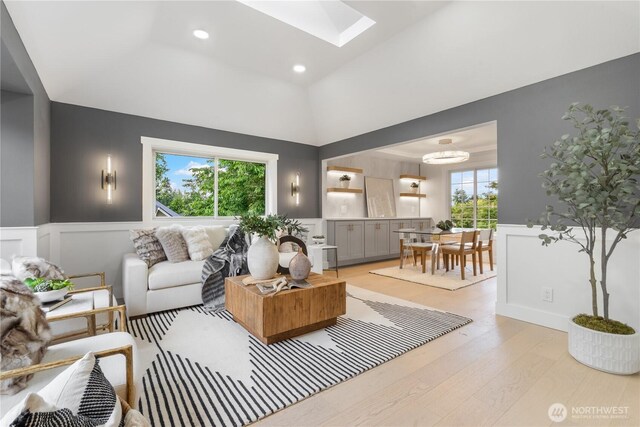 3696 169th Ave NE, Bellevue, WA 98008 - living area with light wood-type flooring, a skylight, wainscoting, a decorative wall, and recessed lighting