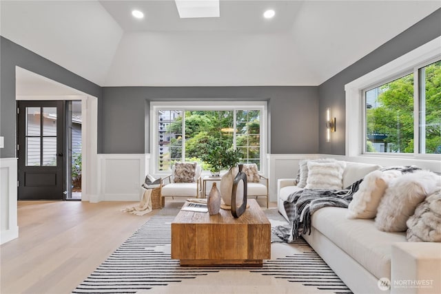3696 169th Ave NE, Bellevue, WA 98008 - living room with healthy amount of natural light, a decorative wall, lofted ceiling, wainscoting, and light wood-style floors
