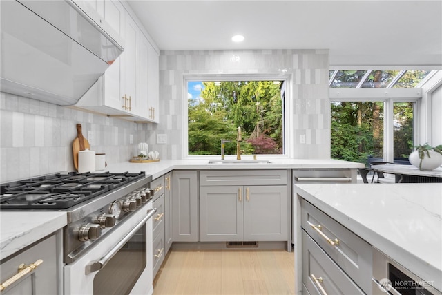 3696 169th Ave NE, Bellevue, WA 98008 - kitchen with appliances with stainless steel finishes, ventilation hood, decorative backsplash, plenty of natural light, and recessed lighting