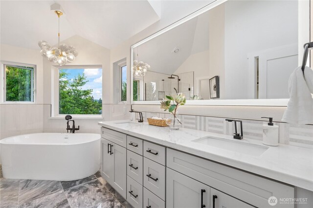 3696 169th Ave NE, Bellevue, WA 98008 - bathroom featuring lofted ceiling, a chandelier, double vanity, a freestanding bath, and tiled shower