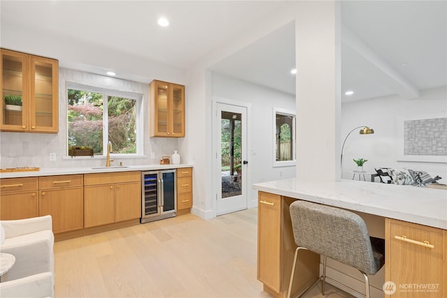 3696 169th Ave NE, Bellevue, WA 98008 - kitchen featuring wine cooler, light wood-style floors, recessed lighting, glass insert cabinets, and tasteful backsplash