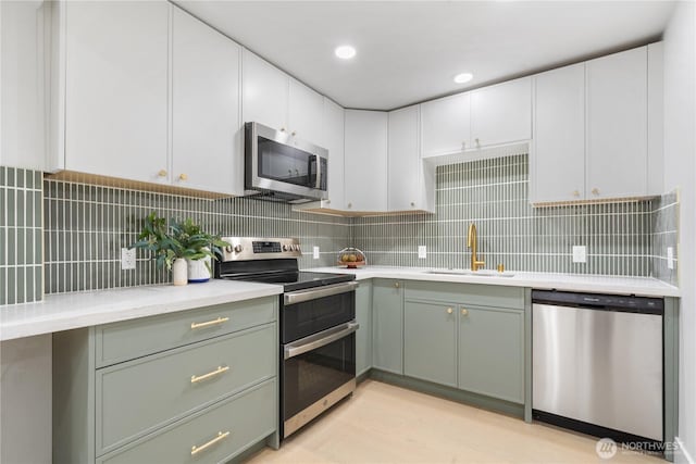 3696 169th Ave NE, Bellevue, WA 98008 - kitchen featuring appliances with stainless steel finishes, light countertops, backsplash, and white cabinetry