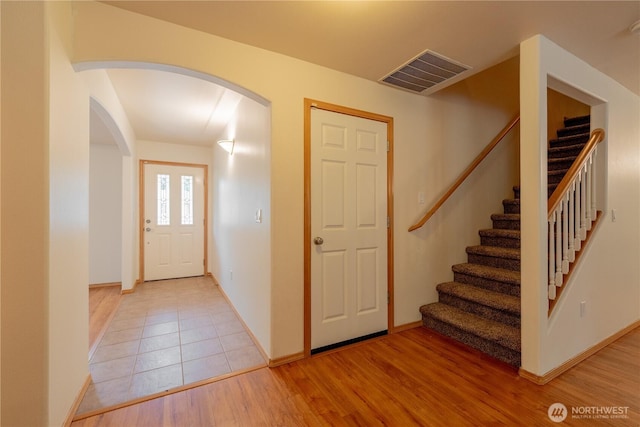 13858 Dogwood Ct, Sultan, WA 98294 - foyer featuring arched walkways, stairs, and light wood-style flooring