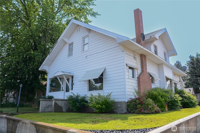 202 E 3rd Ave, Ritzville, WA 99169 - view of side of property with a chimney and a lawn
