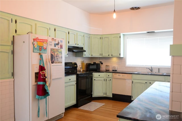 202 E 3rd Ave, Ritzville, WA 99169 - kitchen featuring black appliances, green cabinets, under cabinet range hood, and wood finished floors