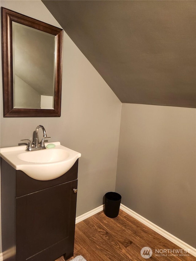 202 E 3rd Ave, Ritzville, WA 99169 - bathroom with wood finished floors, vanity, and vaulted ceiling