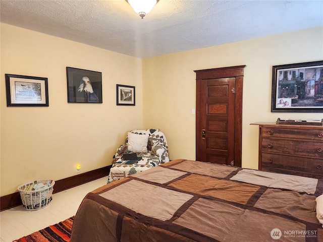 202 E 3rd Ave, Ritzville, WA 99169 - bedroom featuring a textured ceiling and baseboards
