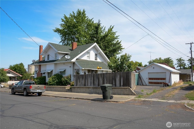 202 E 3rd Ave, Ritzville, WA 99169 - view of front of property with a chimney, a detached garage, and an outdoor structure
