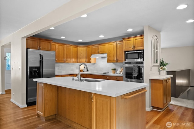 11810 County Line Rd E, Edgewood, WA 98372 - kitchen with appliances with stainless steel finishes, under cabinet range hood, light wood-style floors, light countertops, and recessed lighting