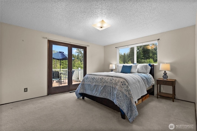 11810 County Line Rd E, Edgewood, WA 98372 - carpeted bedroom featuring access to exterior, multiple windows, a textured ceiling, and french doors