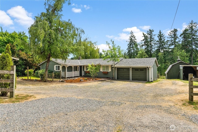 11810 County Line Rd E, Edgewood, WA 98372 - view of front of house featuring dirt driveway, a garage, and a porch