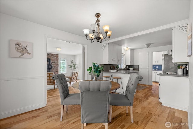 11810 County Line Rd E, Edgewood, WA 98372 - dining room featuring a chandelier and light wood-style flooring