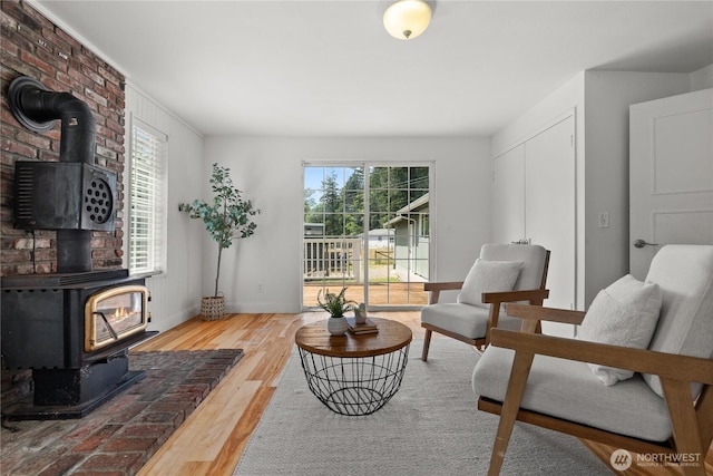11810 County Line Rd E, Edgewood, WA 98372 - living room featuring a wood stove and wood finished floors