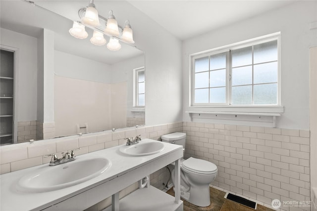 11810 County Line Rd E, Edgewood, WA 98372 - bathroom with tile walls, a wainscoted wall, and double vanity