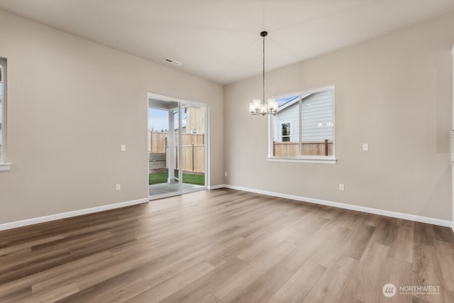 4122 SW Muller Ln SW Unit 311, Port Orchard, WA 98367 - unfurnished room featuring wood finished floors and a chandelier