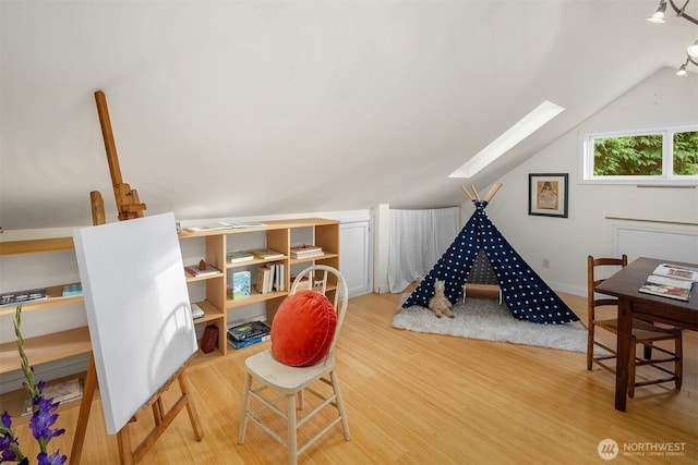 4512 35th Ave W, Seattle, WA 98199 - recreation room featuring a skylight, wood finished floors, and vaulted ceiling