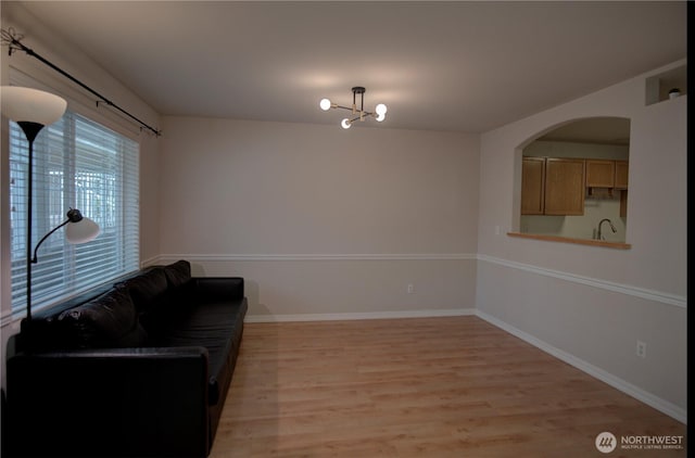 7009 196th St SW Unit A103, Lynnwood, WA 98036 - living area featuring light wood-style floors and arched walkways