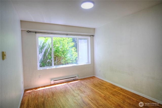 7009 196th St SW Unit A103, Lynnwood, WA 98036 - empty room with a baseboard heating unit and wood finished floors